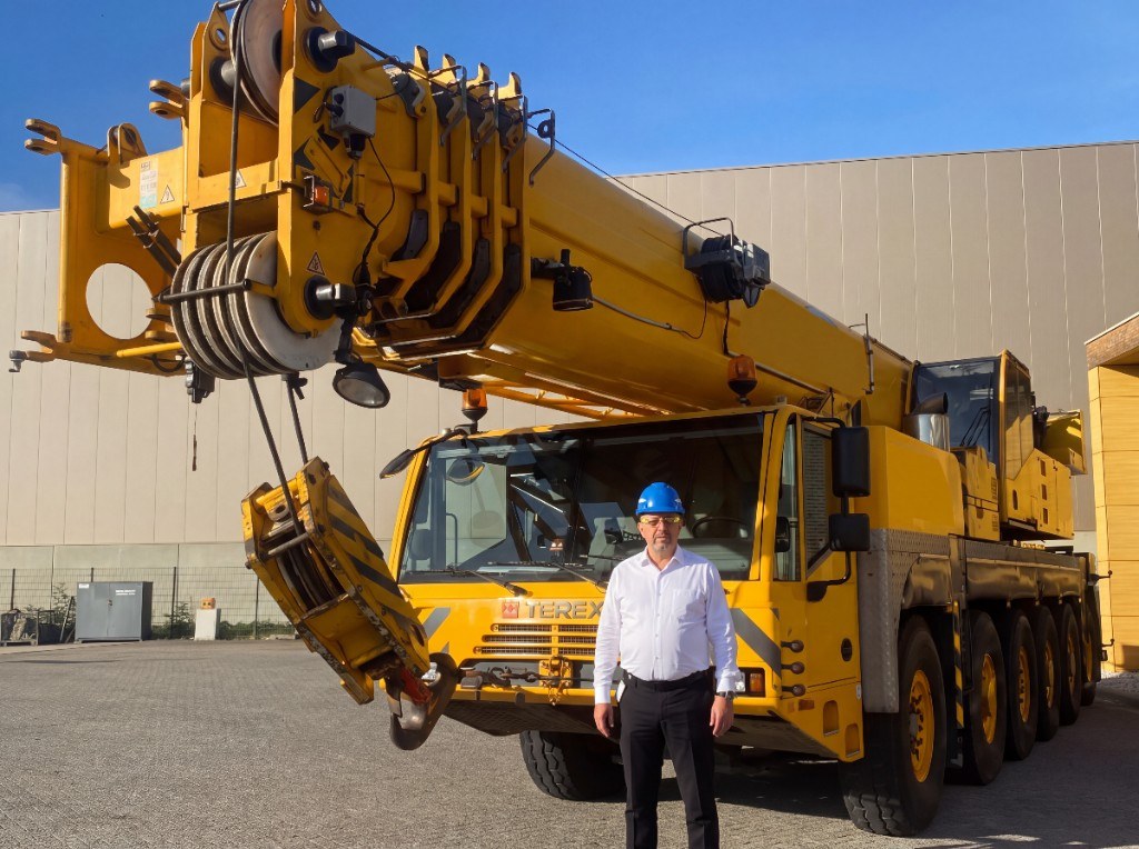 Egemen Mustafa Sener on site in front of a TEREX crane